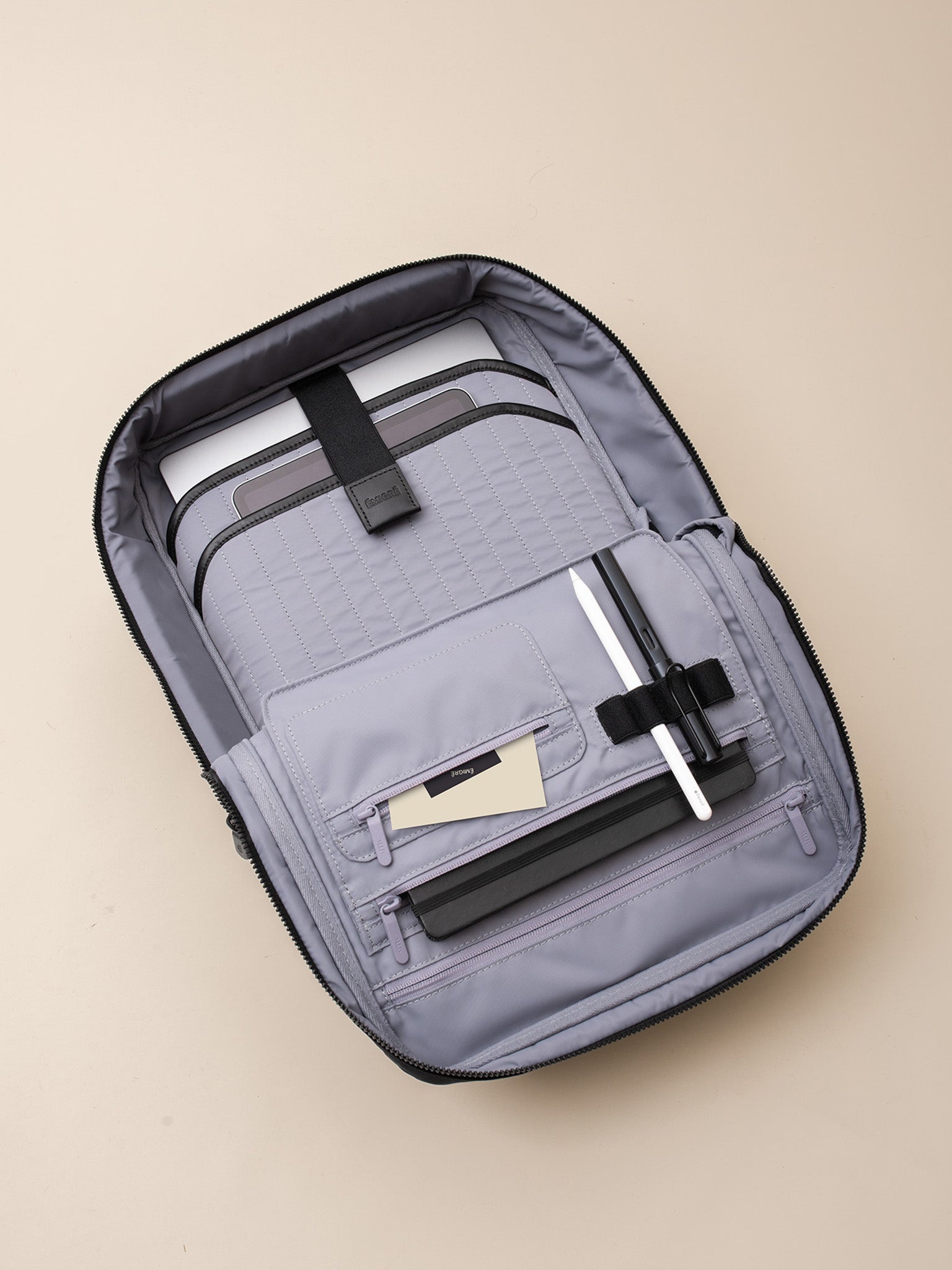 A sleek gray business backpack with a front pocket and padded straps, perfect for commuting and carrying a laptop and other essentials.