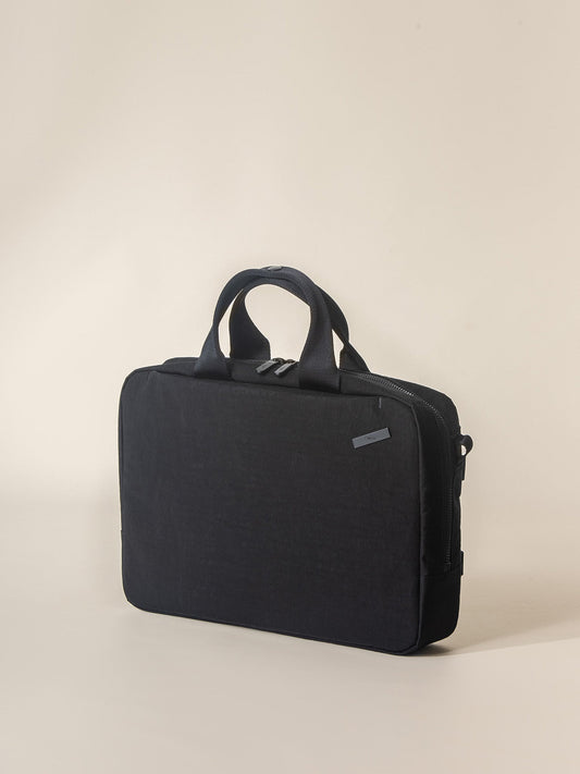 A modern and functional black briefcase for men with a padded laptop compartment.