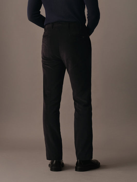 Back view of men’s corduroy trousers showing clean tailored silhouette