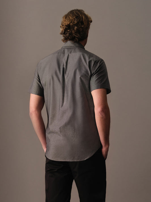Back view of men’s grey short sleeve shirt showing smooth drape and tidy hem length