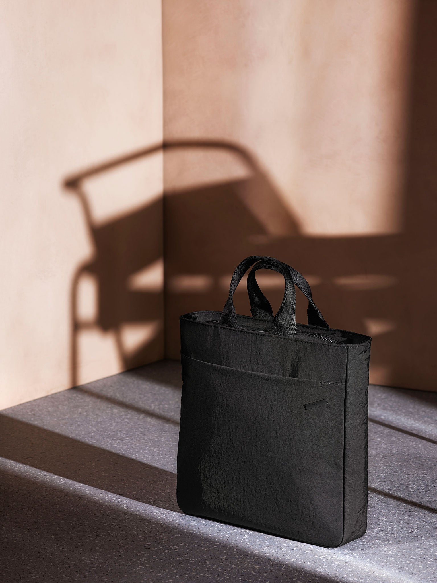 A stylish and practical black tote bag for men. Ideal for business travel