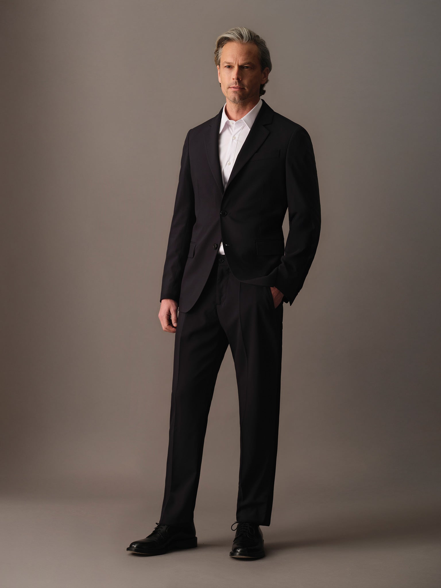 Full-body look wearing tailored wool blazer for men paired with matching trousers