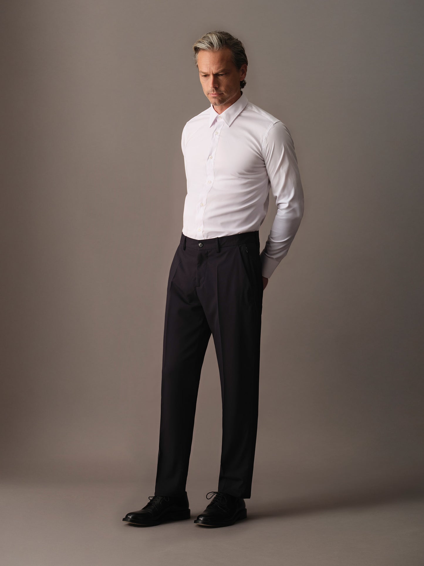 Full-length view of pants for men in Nordic Blue paired with white shirt