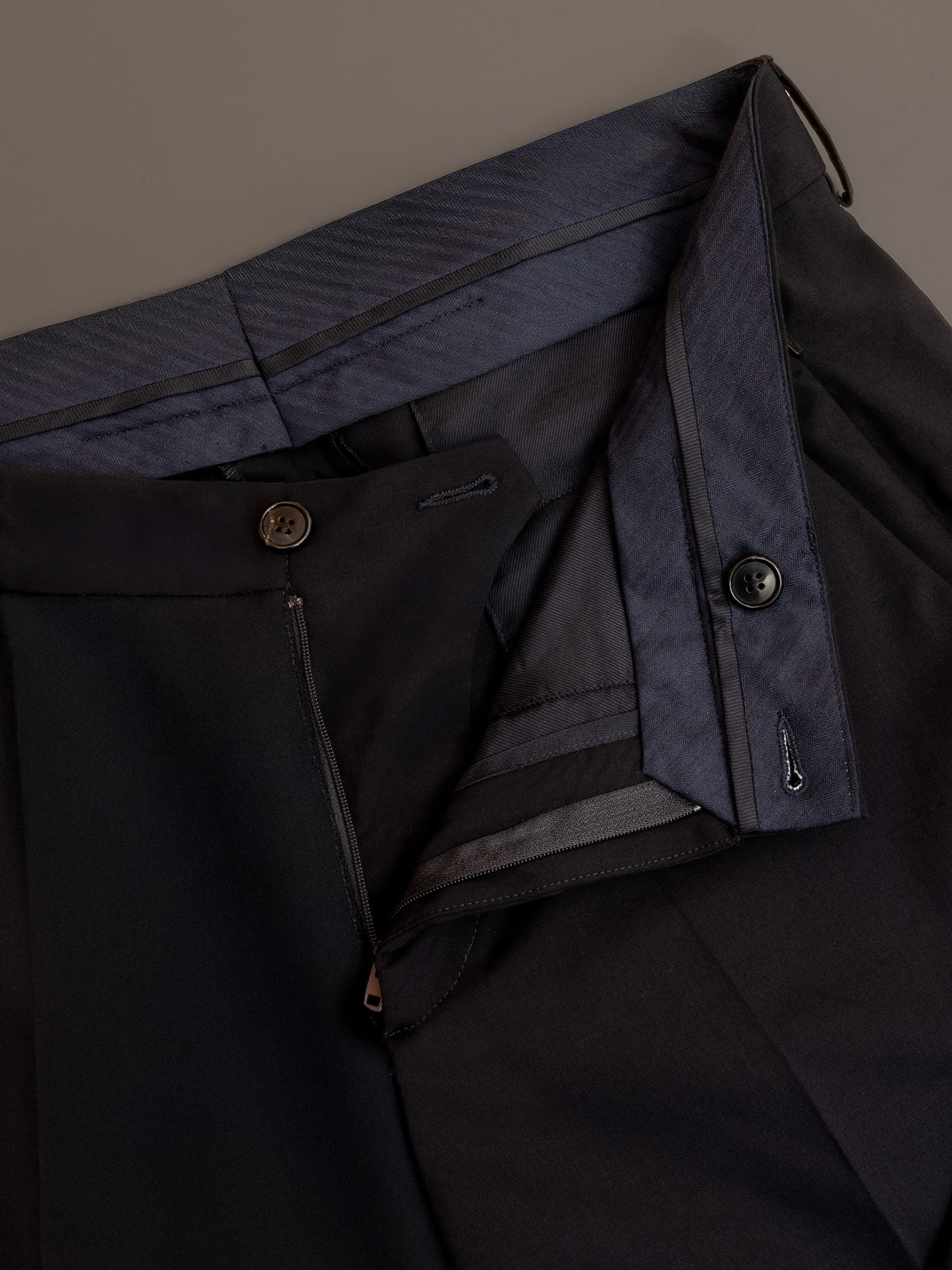 Interior fly construction and French fly detail on all-season men’s trousers