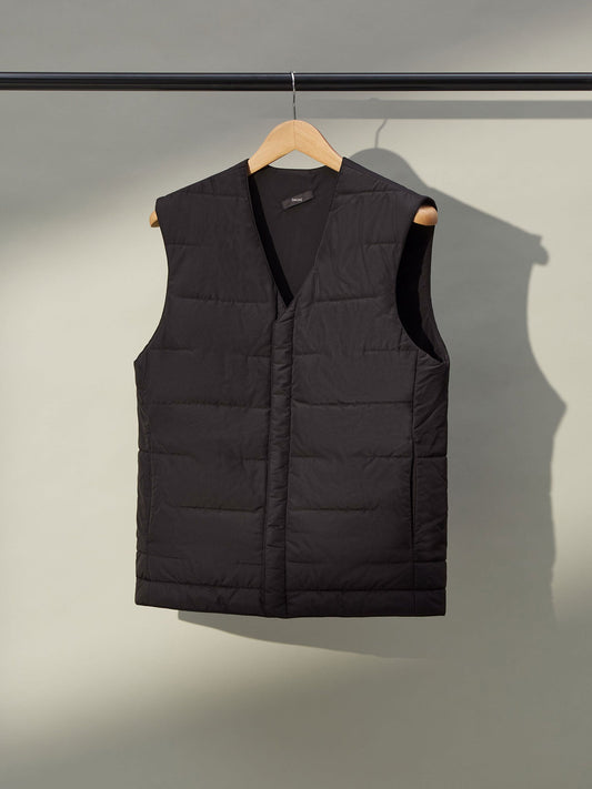 A close-up of a men's grey gilet with a front zipper and two pockets.