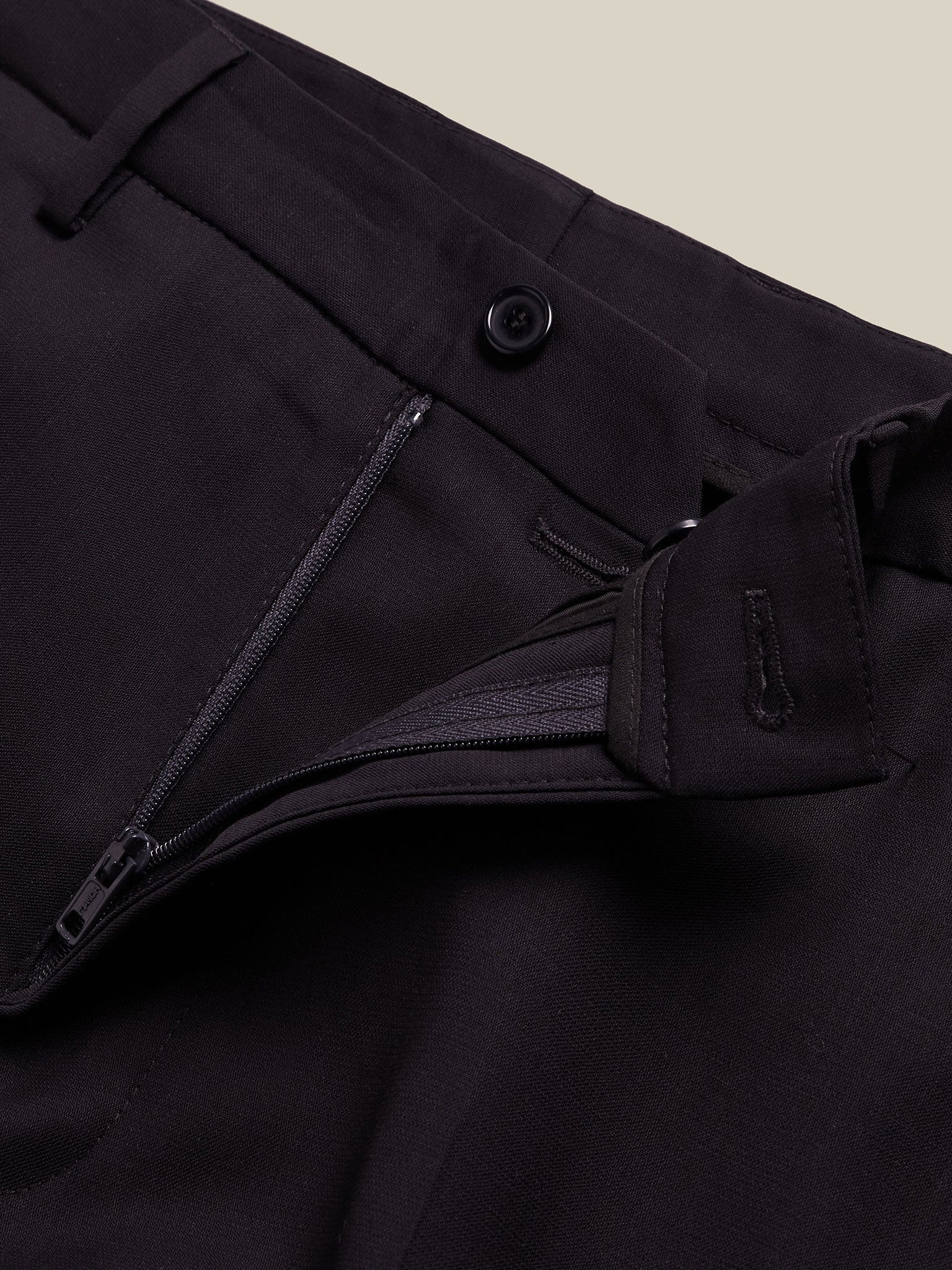 Tailored men's blue wool trousers with slim fit and natural texture