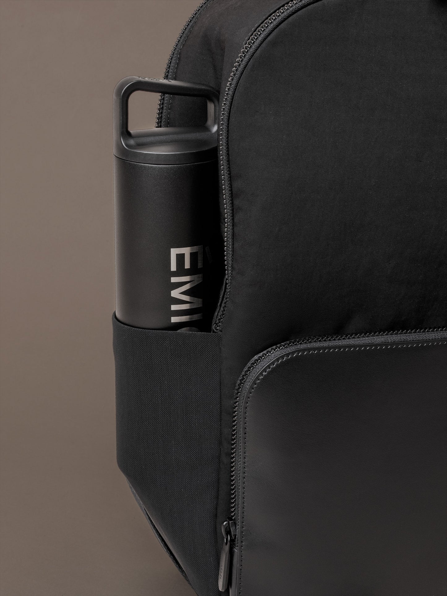 Side pocket detail on The Boardroom Backpack with bottle storage for commuting