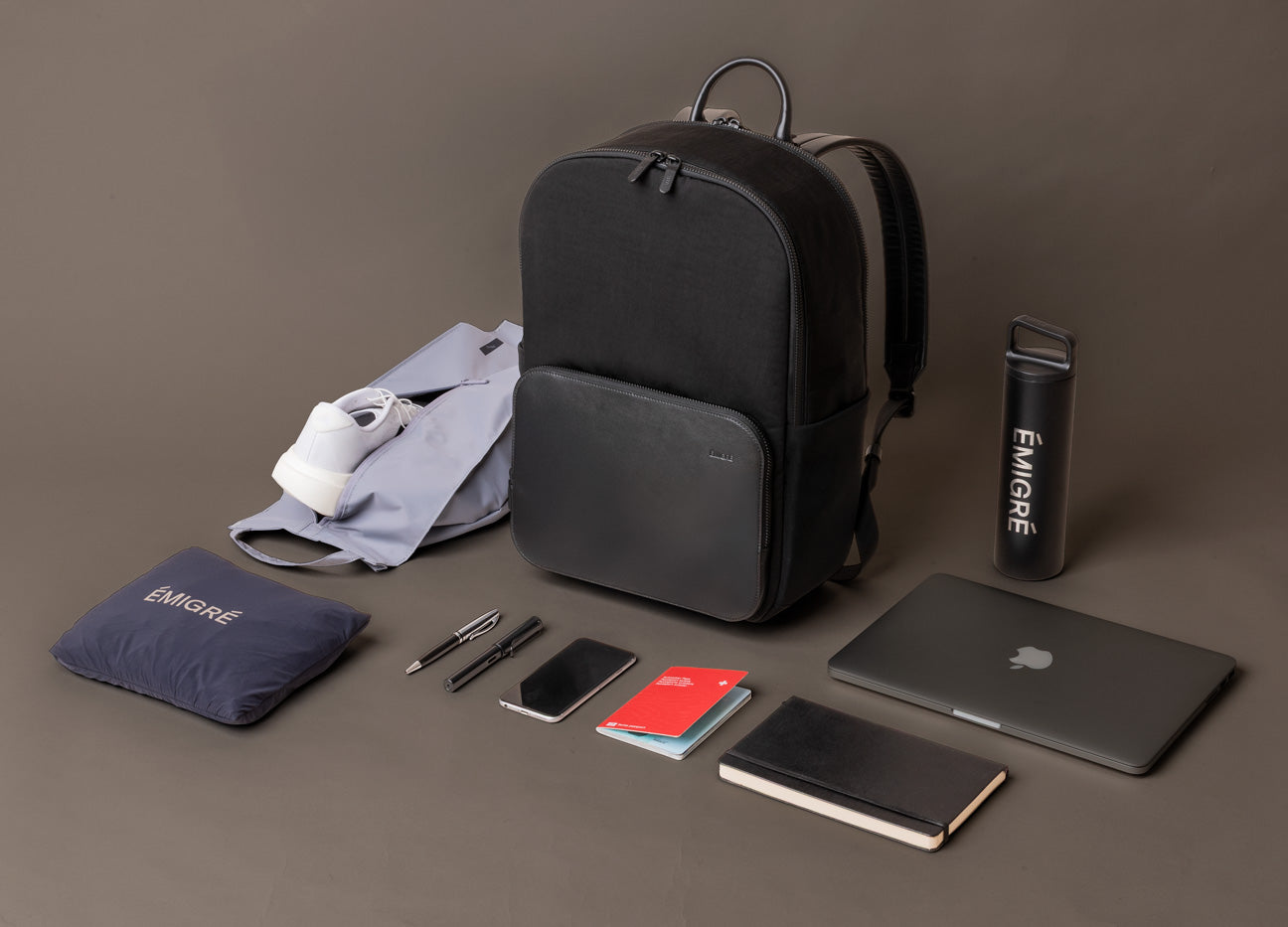 The Boardroom Backpack for men styled with laptop notebook passport and daily carry items