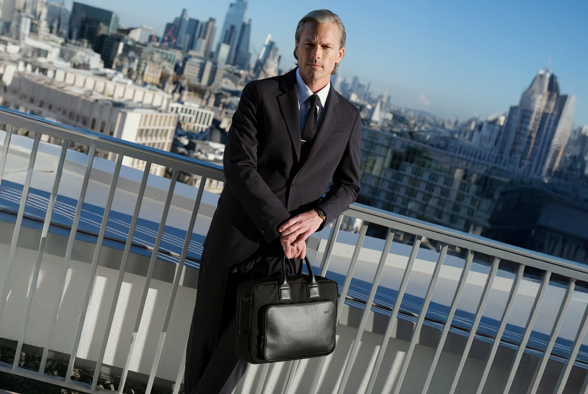 Mens briefcase carried by model in a professional urban setting, designed for modern work and travel