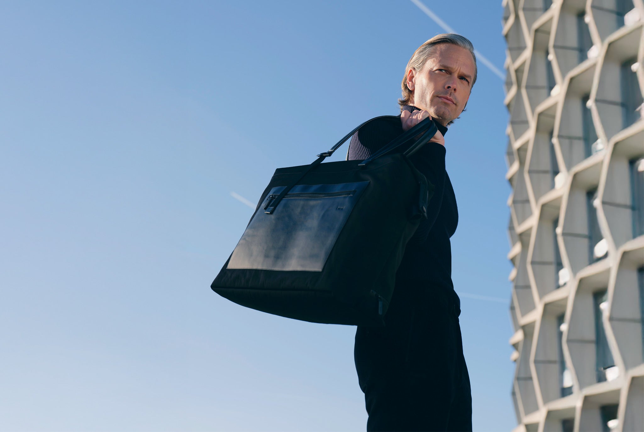 Men tote bag for work carried in a professional urban setting