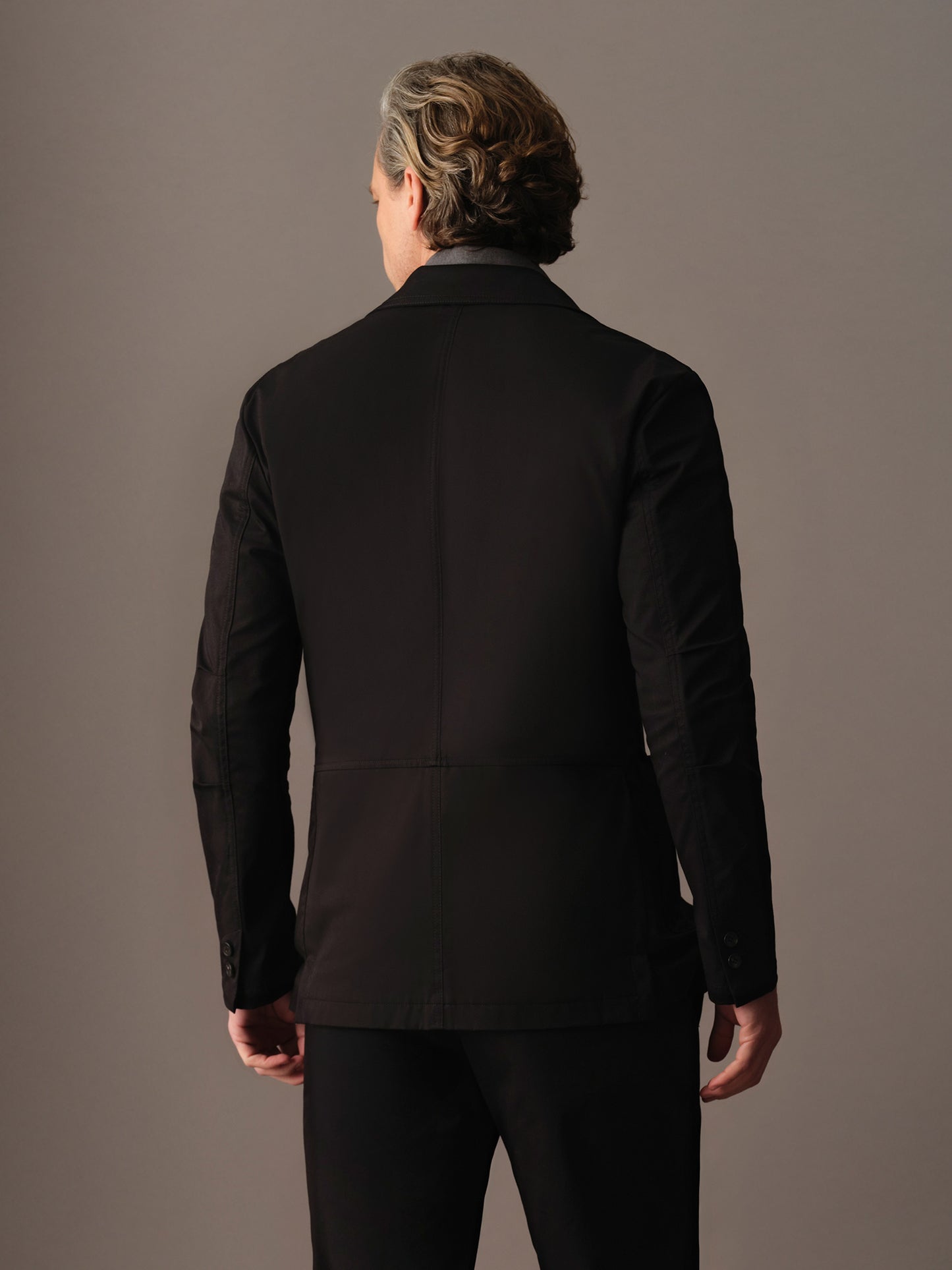 Back view of men’s cotton blazer showing clean lines and structured silhouette