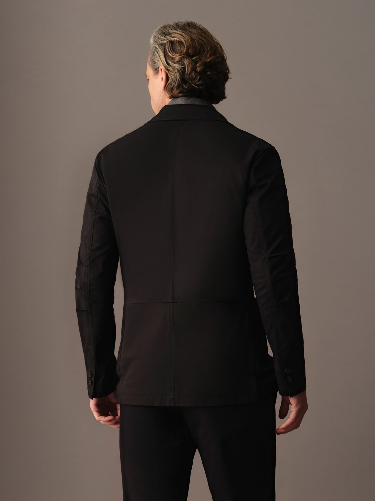 Back view of men’s cotton blazer showing clean lines and structured silhouette