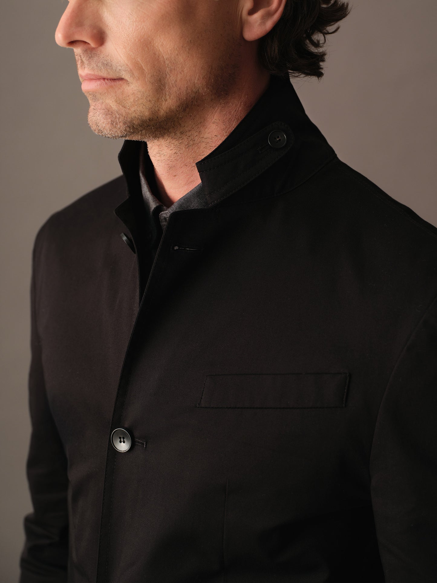 Close-up of collar and throat latch detailing on the men’s cotton blazer
