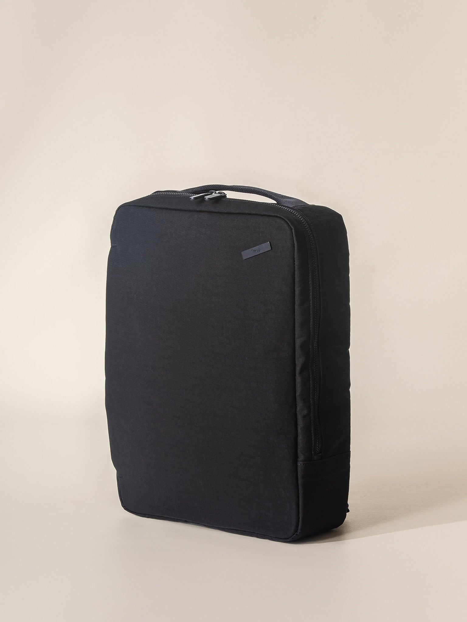 A lightweight and compact black backpack for travel, designed to fit under an airplane seat and carry your laptop, passport, and other important items.