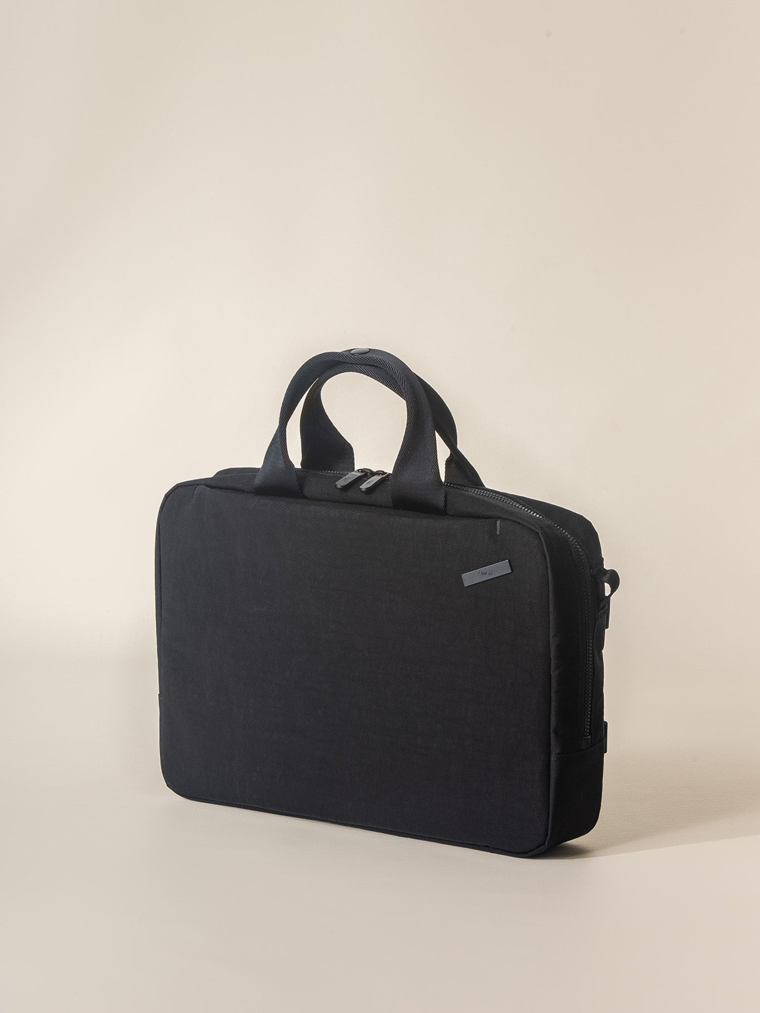 A modern and functional black briefcase for men with a padded laptop compartment.